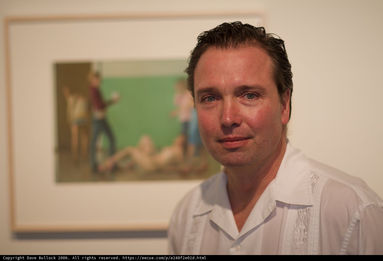 Man in White Shirt Admires Painting