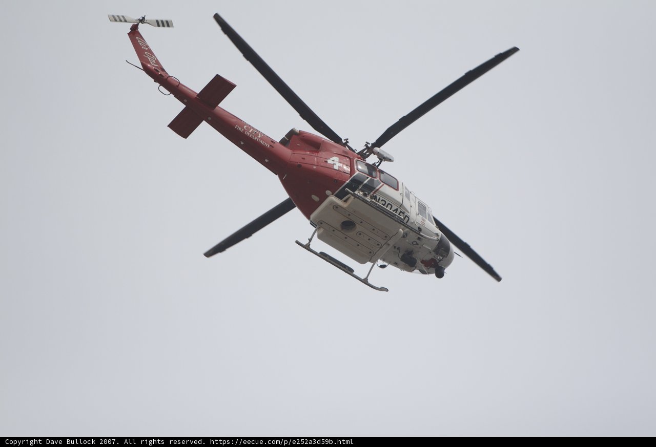 Red and White Helicopter Taking Flight