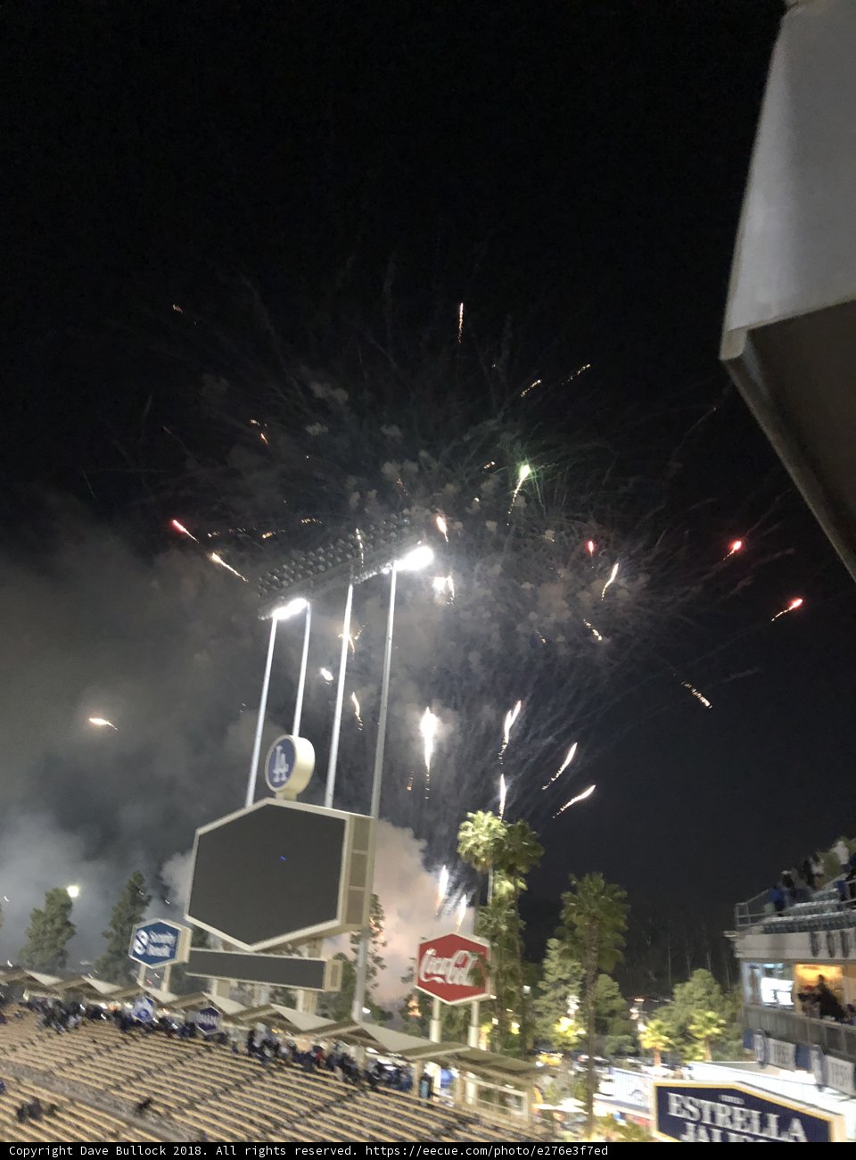 Fireworks illuminate the night sky over baseball stadium
