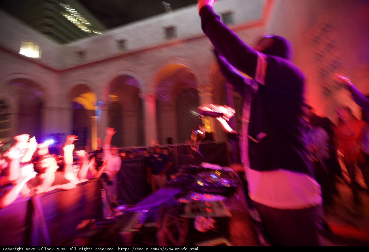 DJ spinning at a crowded urban nightclub