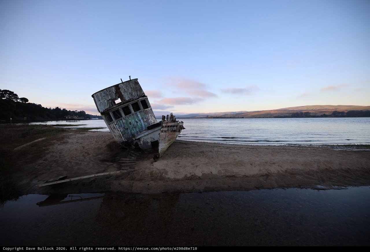 Abandoned Shipwreck at Twilight on Coastal Beach
