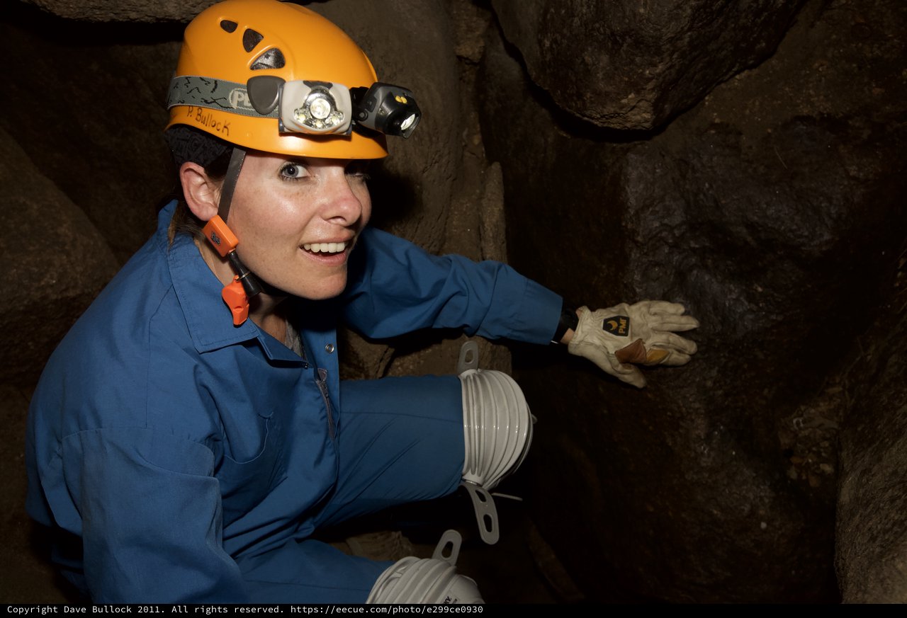 Caver Explores Underground Passage with Headlamp