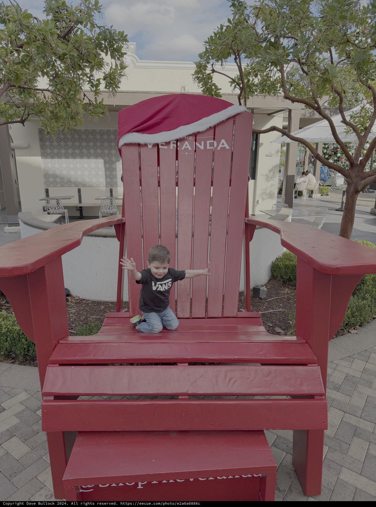 Child Playing on Giant Red Adirondack Chair