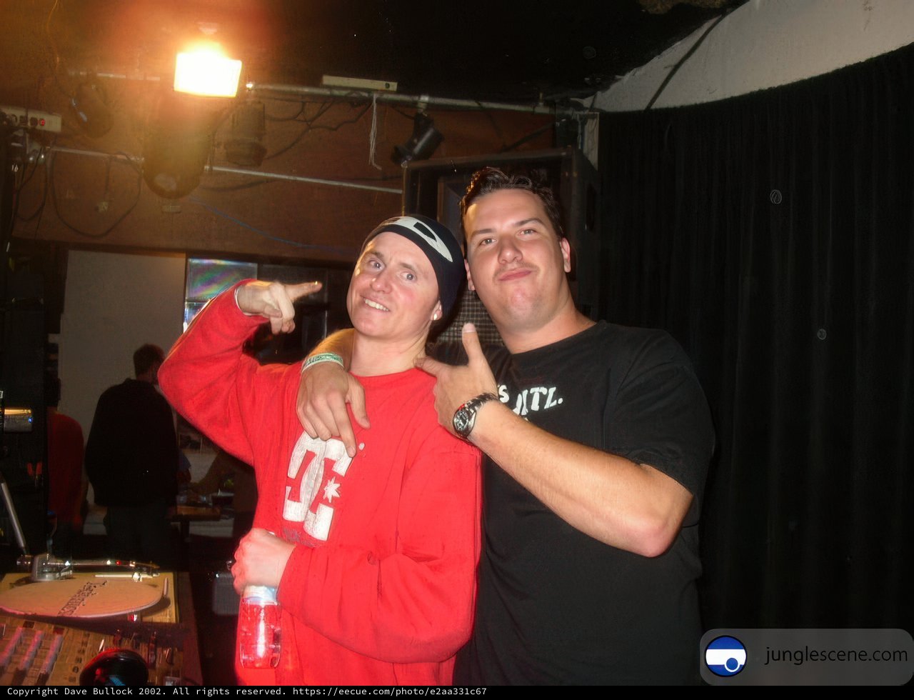 Two Men Strike a Pose at a Party