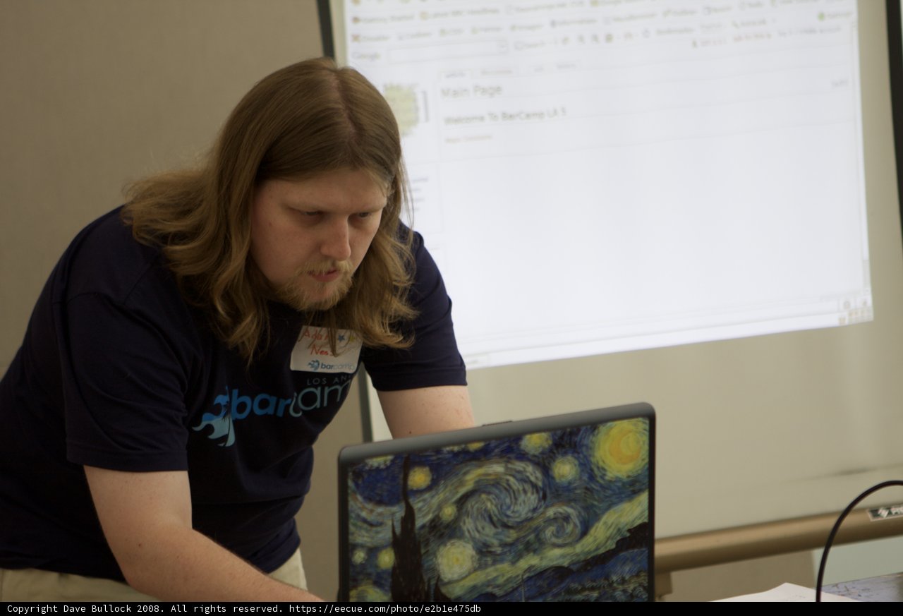 Long-haired Man Typing Away on Laptop
