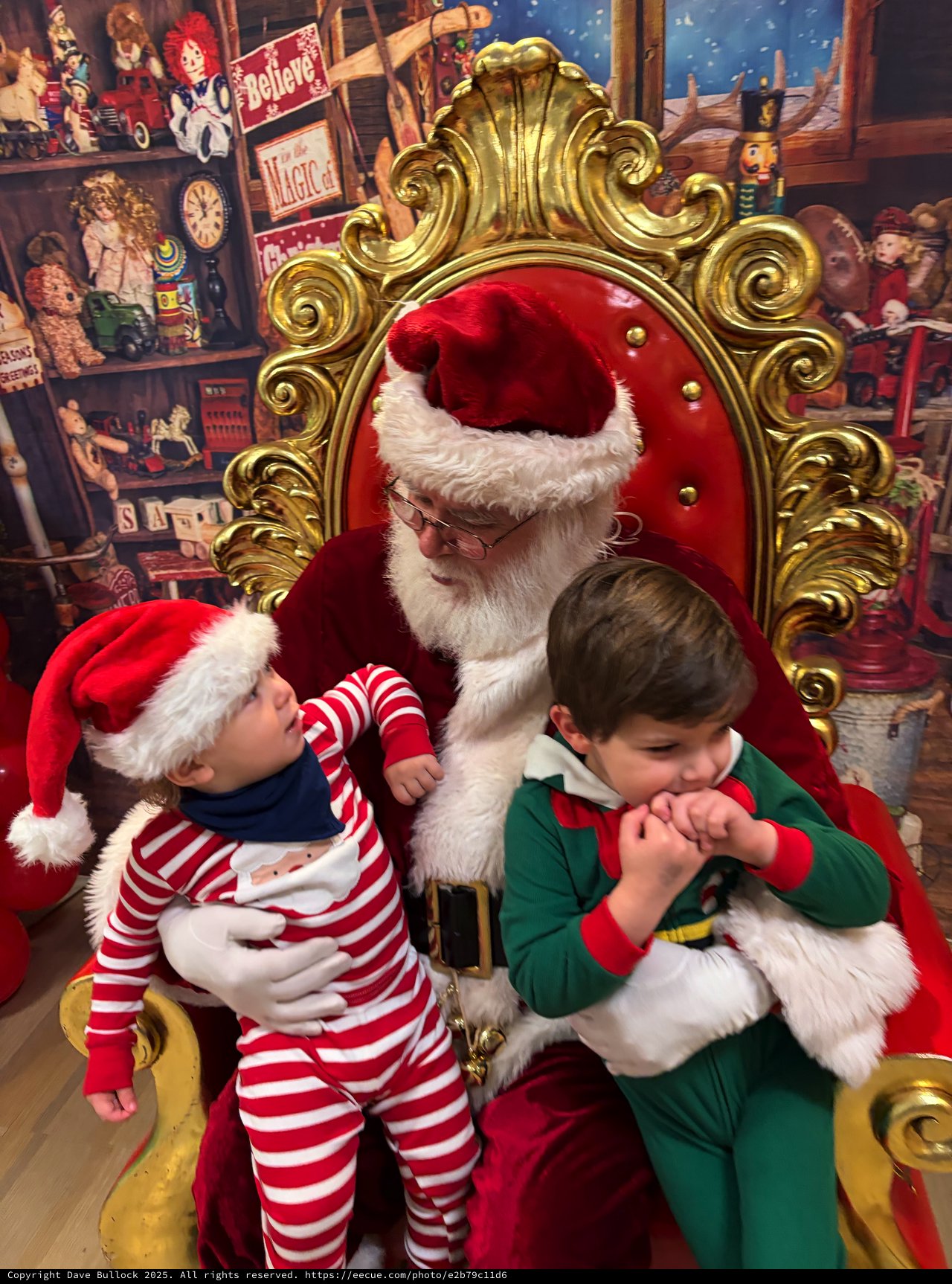 Two Children Visit Santa in His Toy Workshop