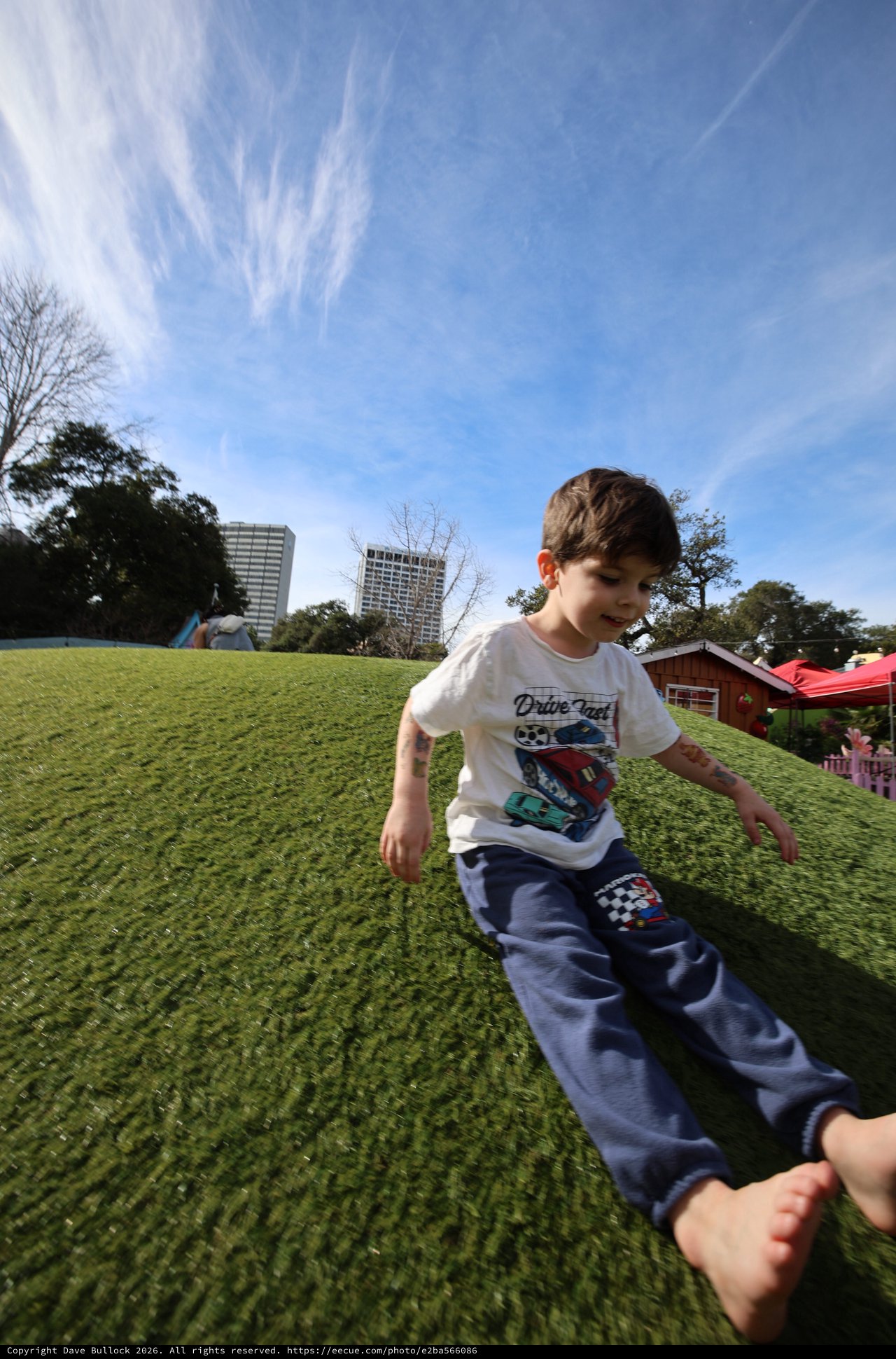 Joyful Child Running Barefoot on Sunny Park Hill