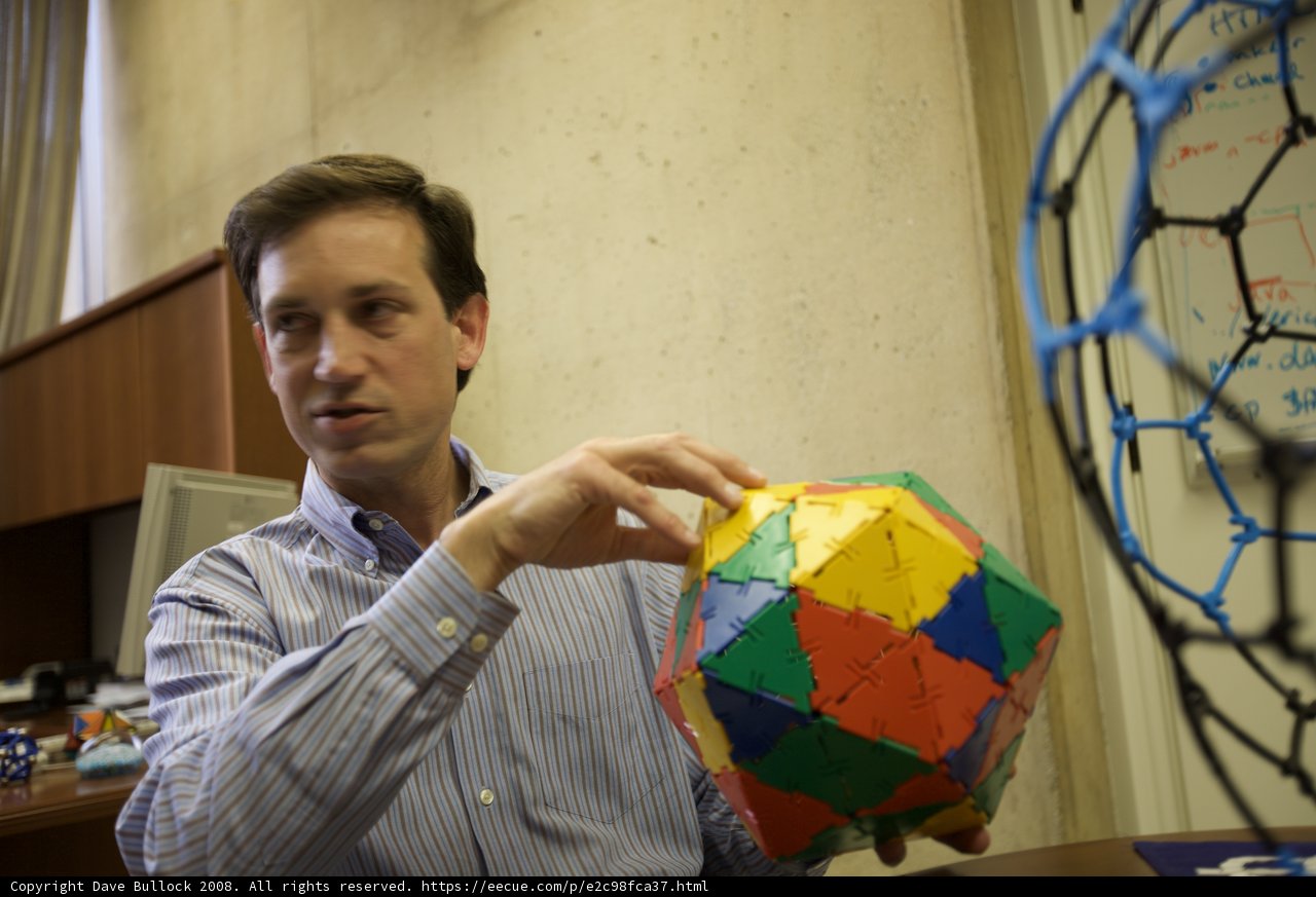 Colorful sphere held by man