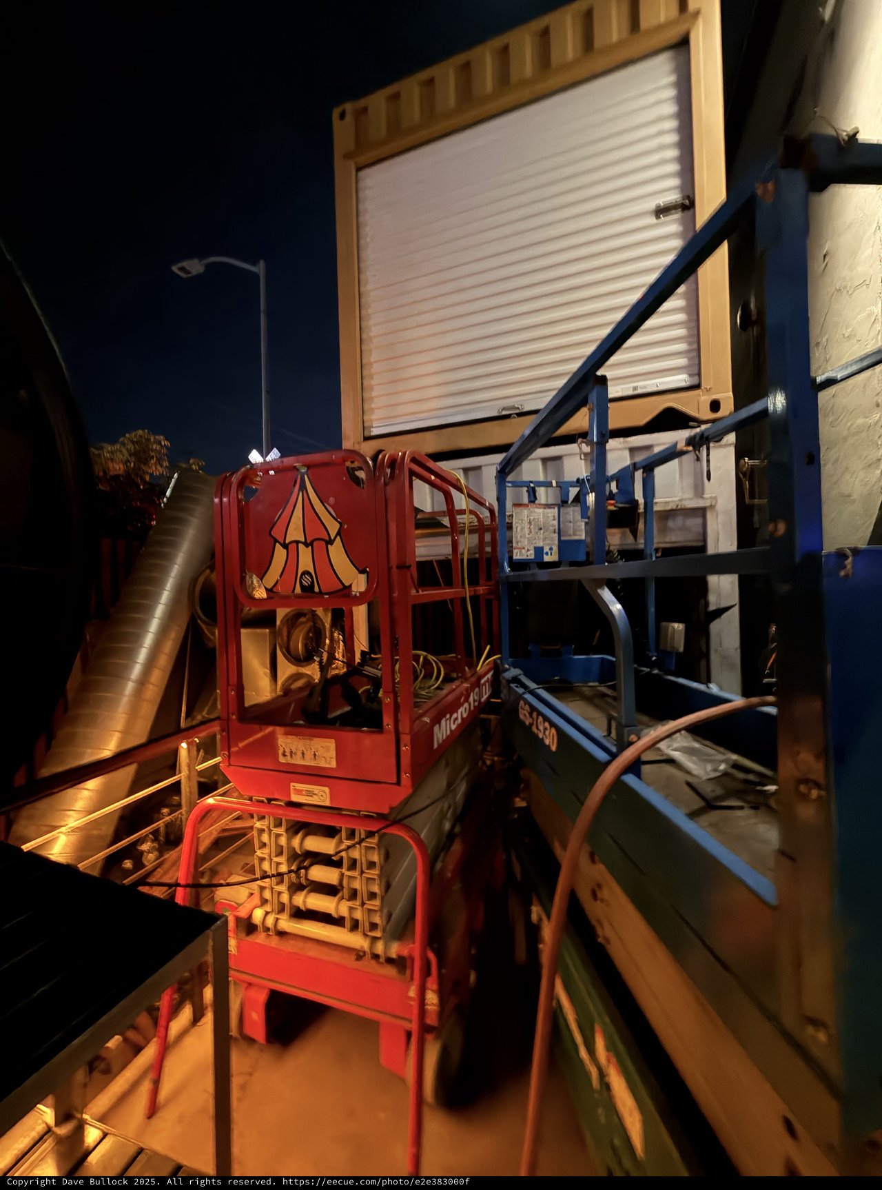 Red Scissor Lift at Night Industrial Loading Dock