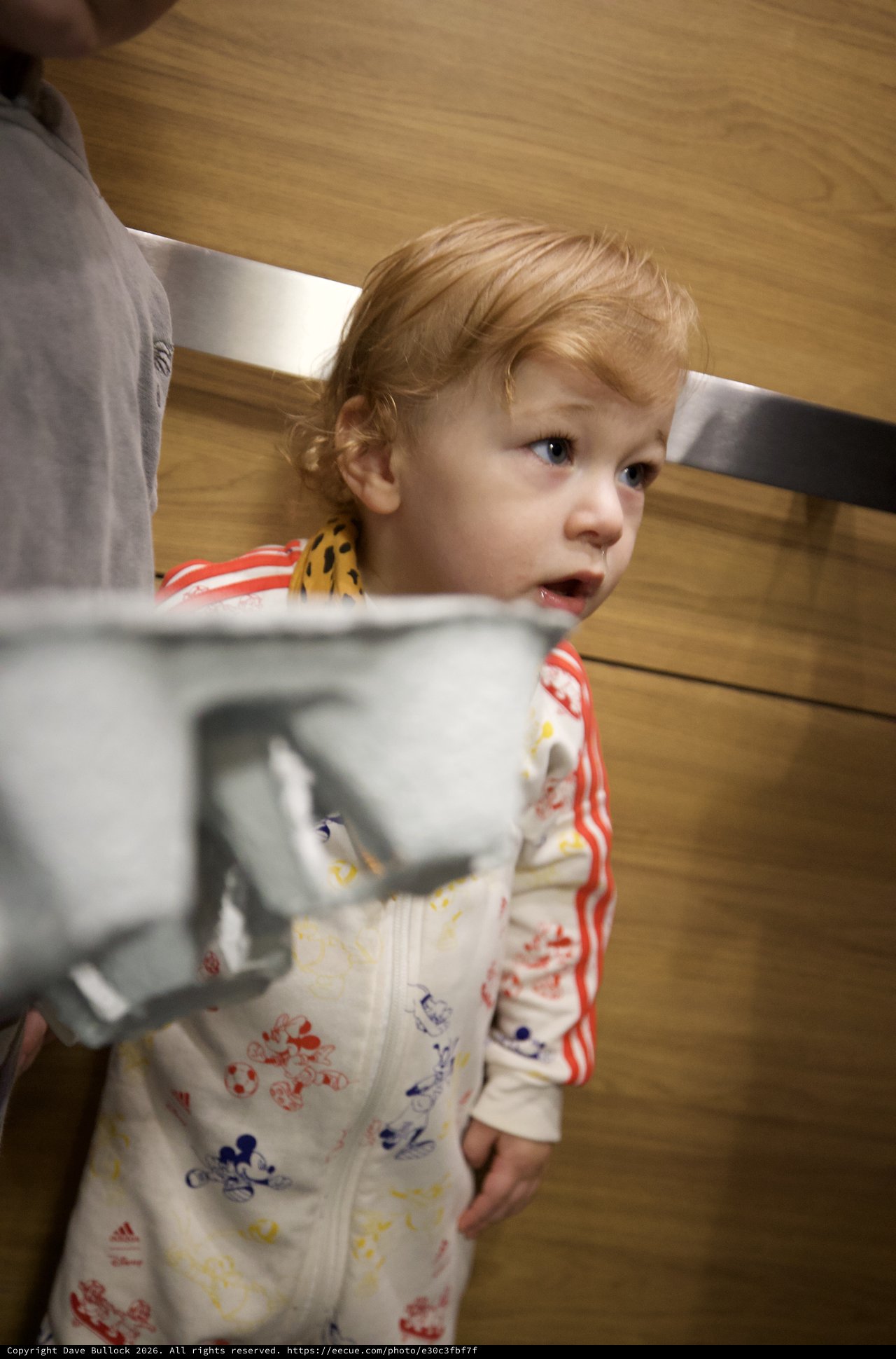 Curious Toddler in Mickey Mouse Pajamas at Home