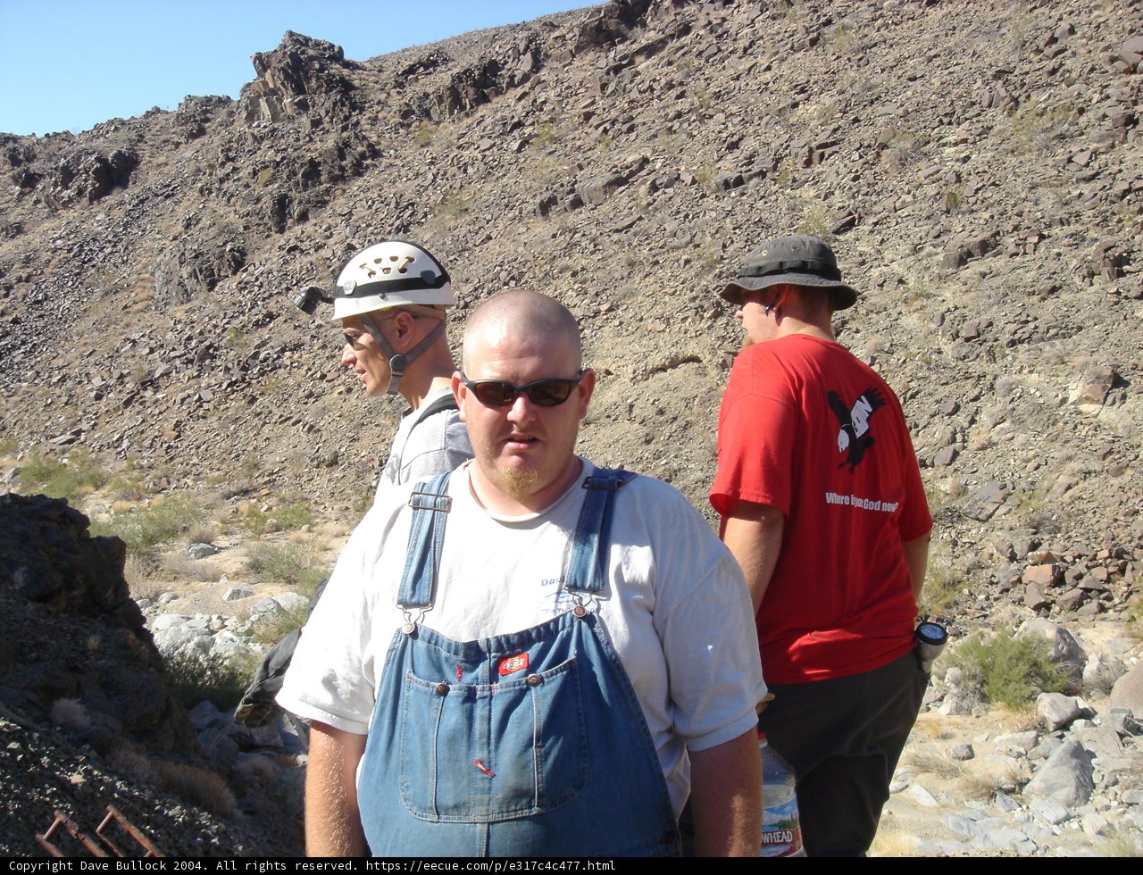 Man in Overalls Surveying Hillside