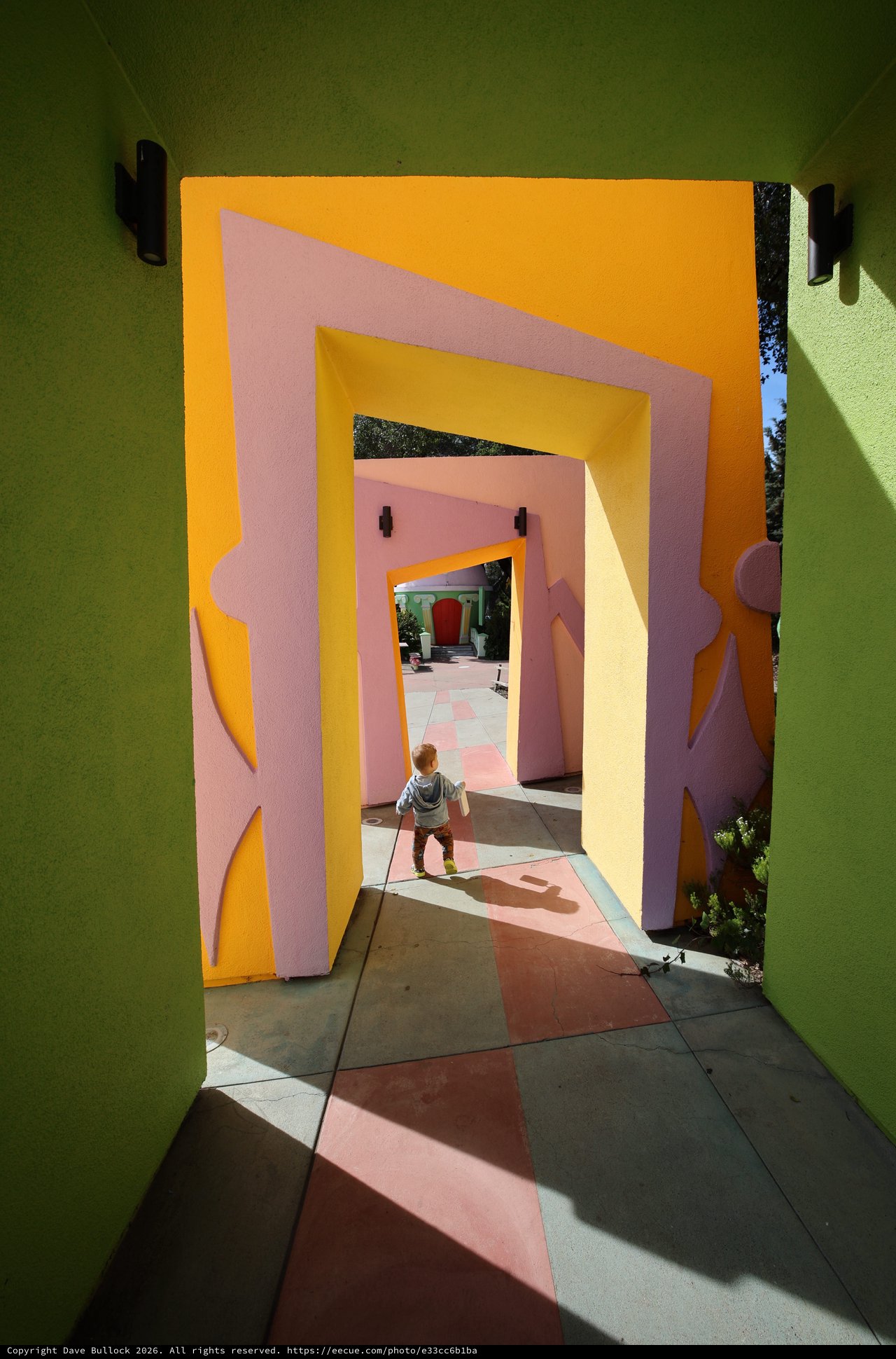 Child Walking Through Colorful Architectural Tunnels at Fantasyland