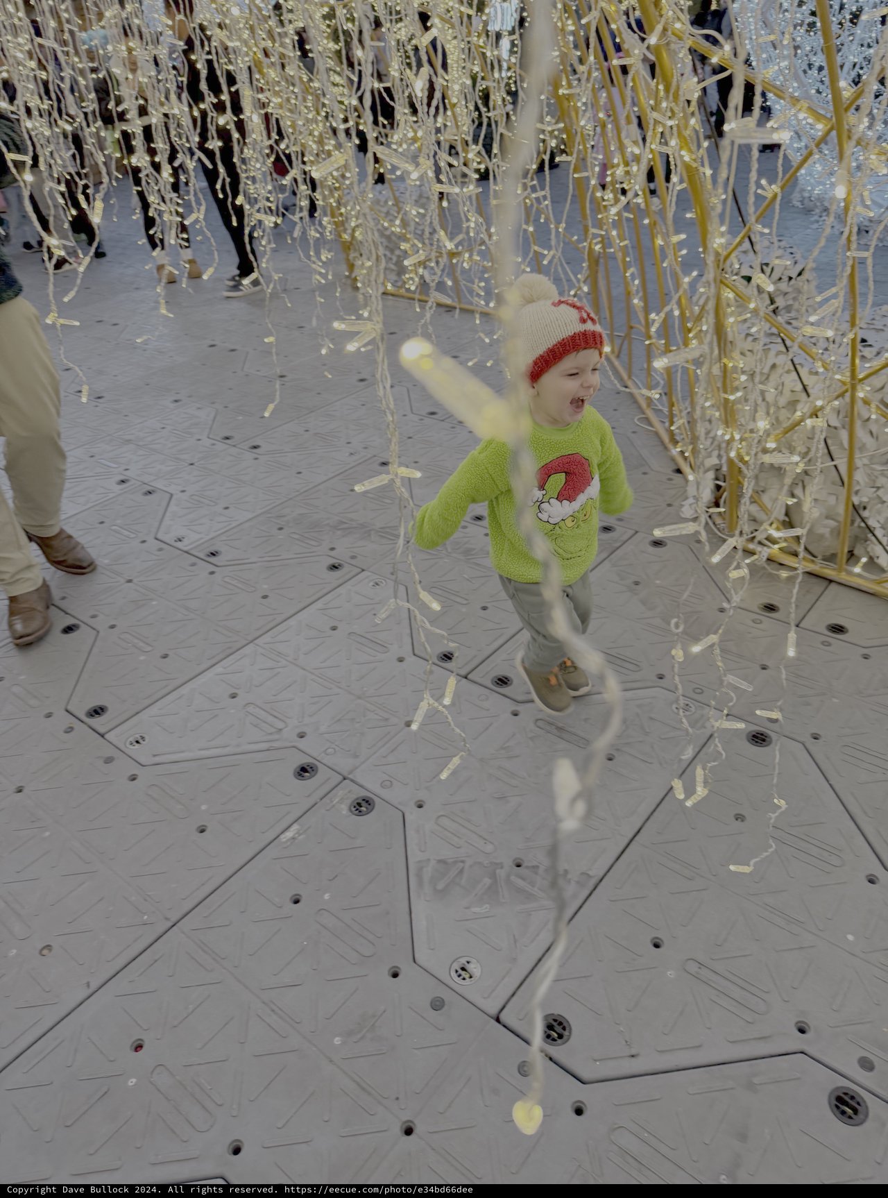 Child Playing in Golden Streamer Installation