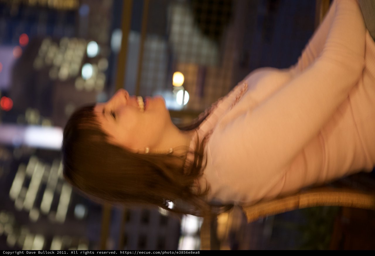 Laughing Woman Against Glittering City Night Lights