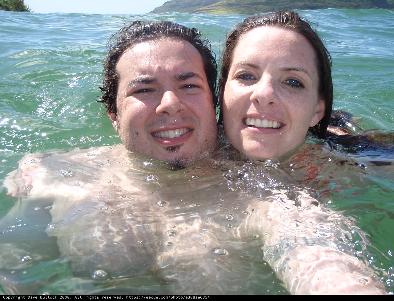 Couple Swimming Together in Hawaiian Ocean Waters