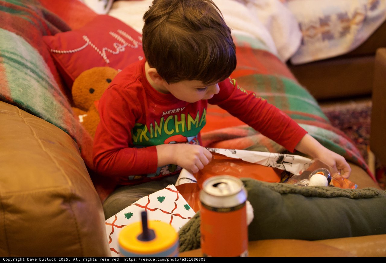 Child Opening Christmas Presents on Christmas Morning