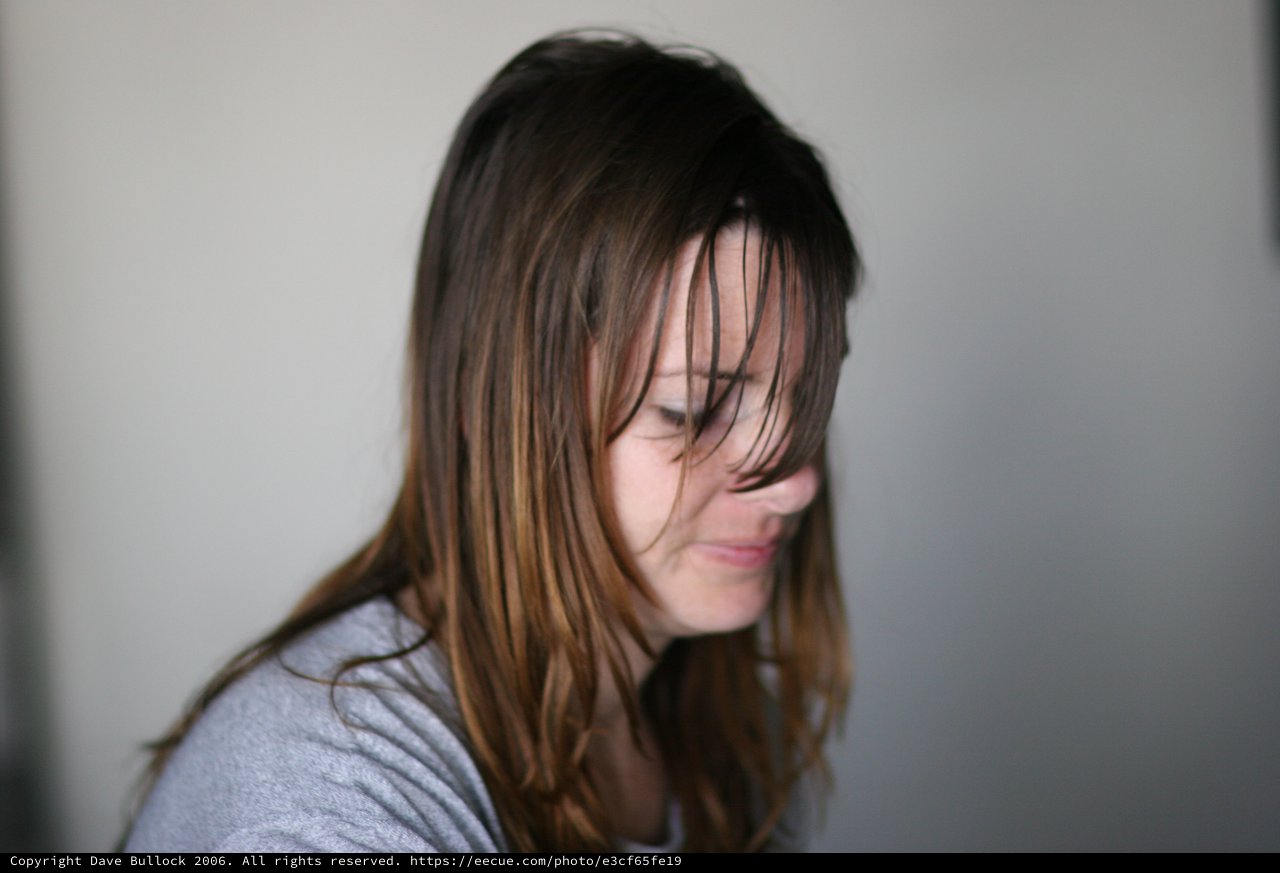 Windswept Hair Across a Pensive Woman's Face