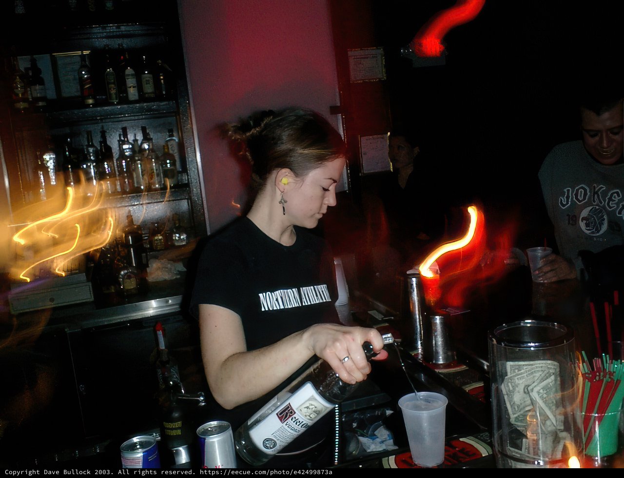 Bartender pours drinks for patrons at the pub
