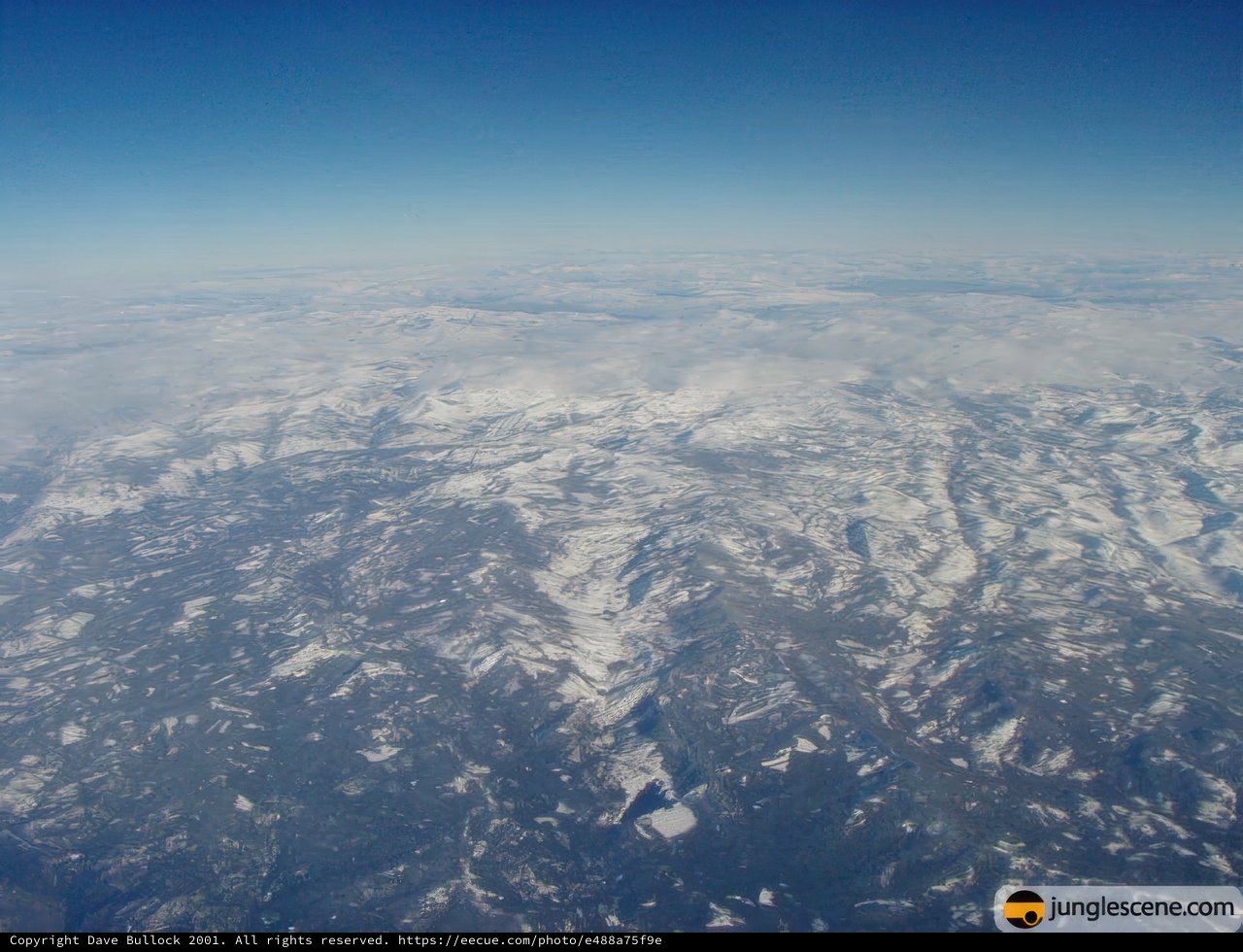 Majestic Snowy Mountains From An Airplane Window