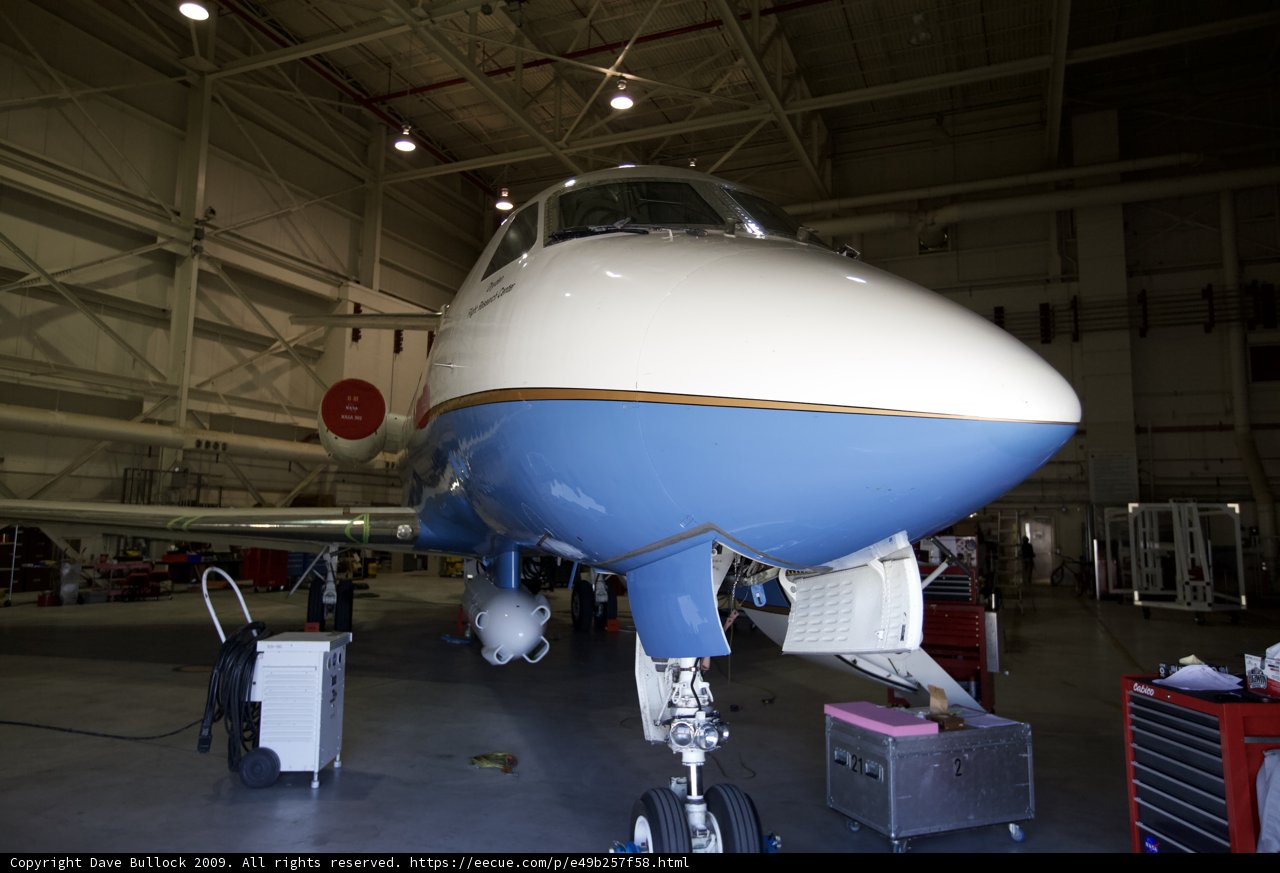 White and Blue Airplane Parked in the Hangar