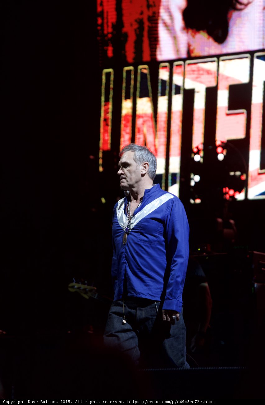 Morrissey Three Quarter Portrait Blue Shirt Pensive UNITED Union Jack Video Screen Gray Hair