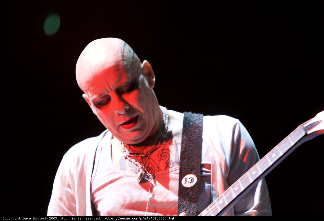 Bald Man Rocks the Stage with his Guitar