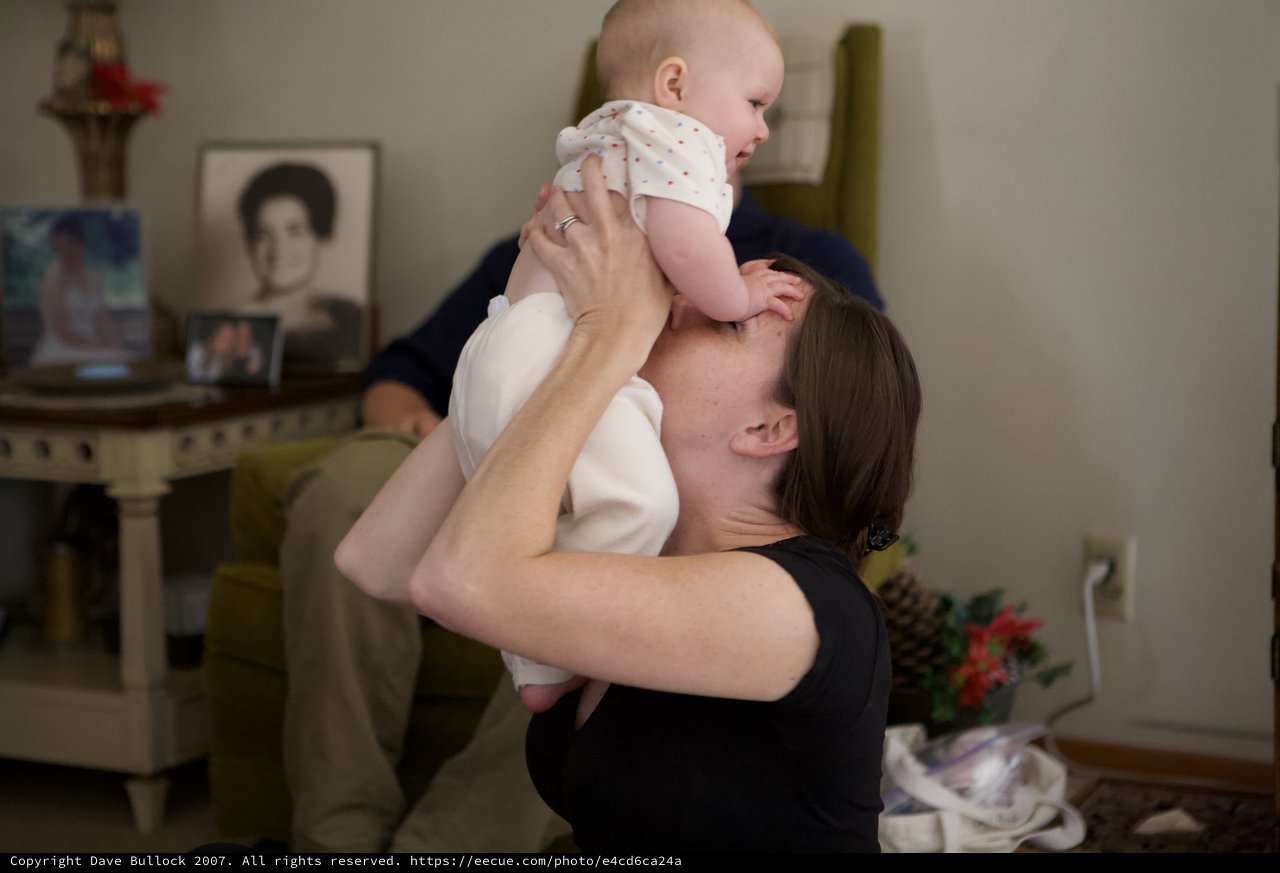 Mother Lifts Laughing Baby with Pure Joy