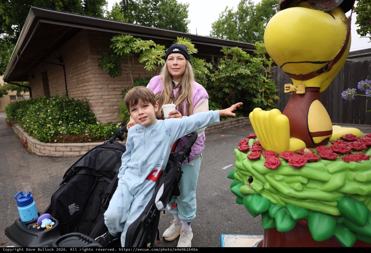 Mother and Child Pose with Woodstock Cartoon Statue