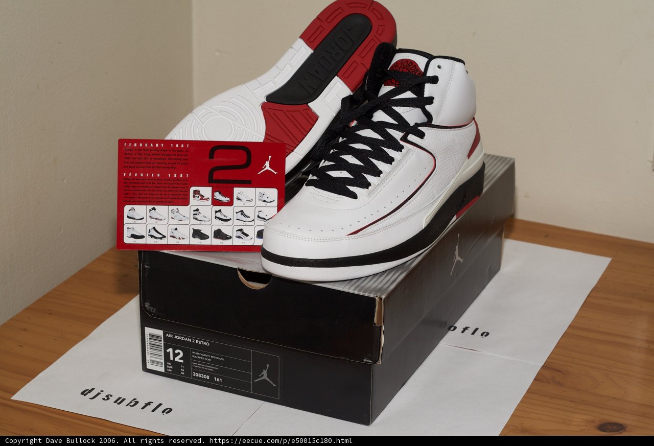 Red and White Sneakers on Wooden Table