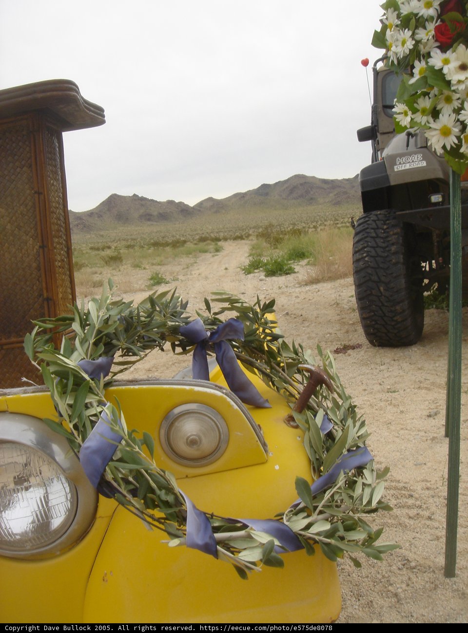 Yellow Car Adorned with a Flower Wreath