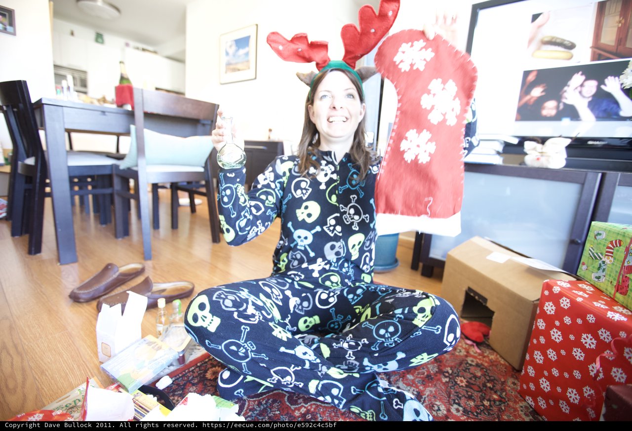 Joyful Christmas Morning in Skull Pajamas and Reindeer Antlers