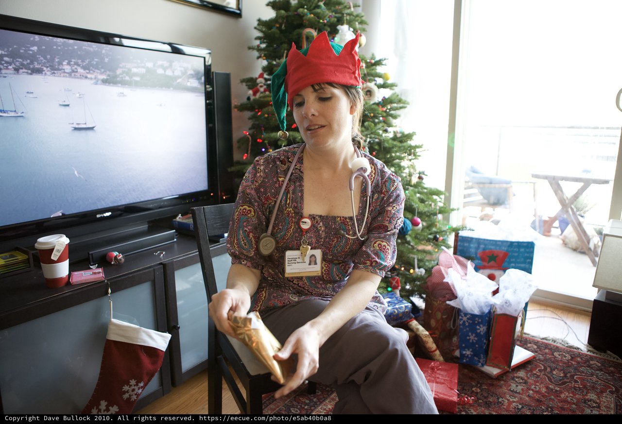 Nurse Elf Opens Christmas Gift at Holiday Gathering
