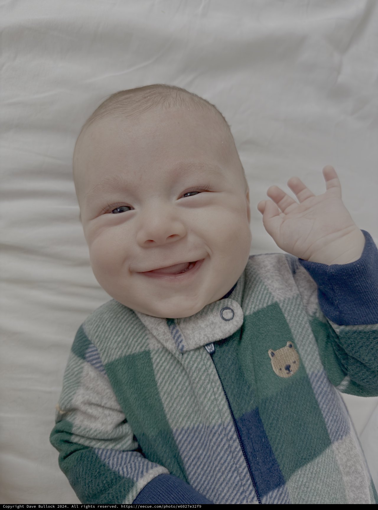 Adorable Baby Waving in Plaid Pajamas