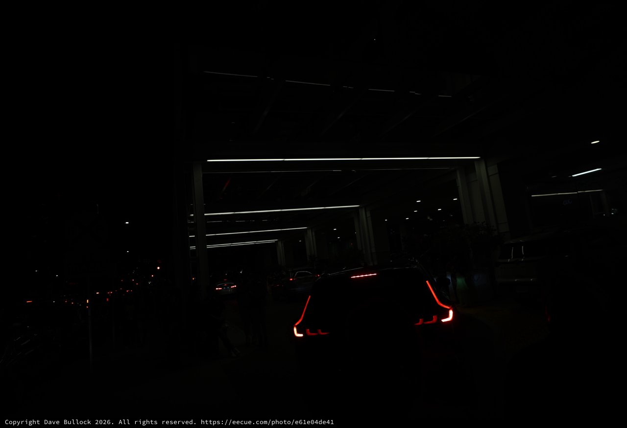 Glowing Taillights Queue at Night Festival Entrance