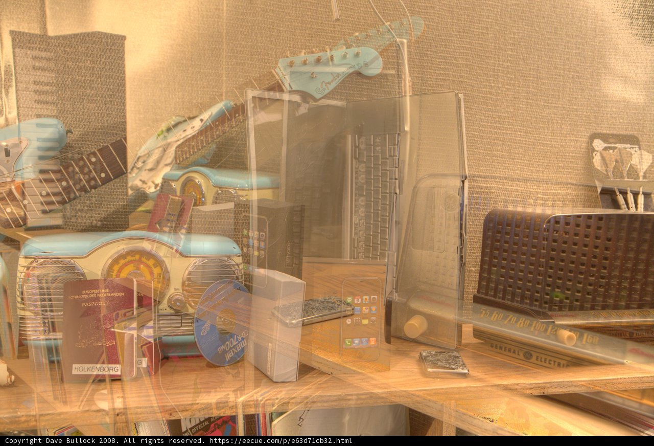 Table cluttered with musical instruments, hardware and electronics.