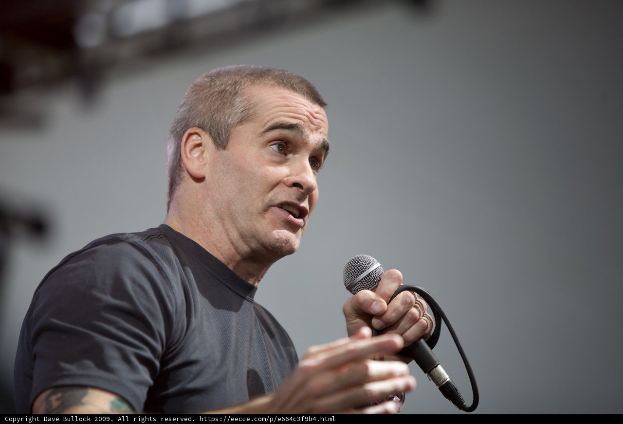 Henry Rollins Takes the Stage with Microphone in Hand