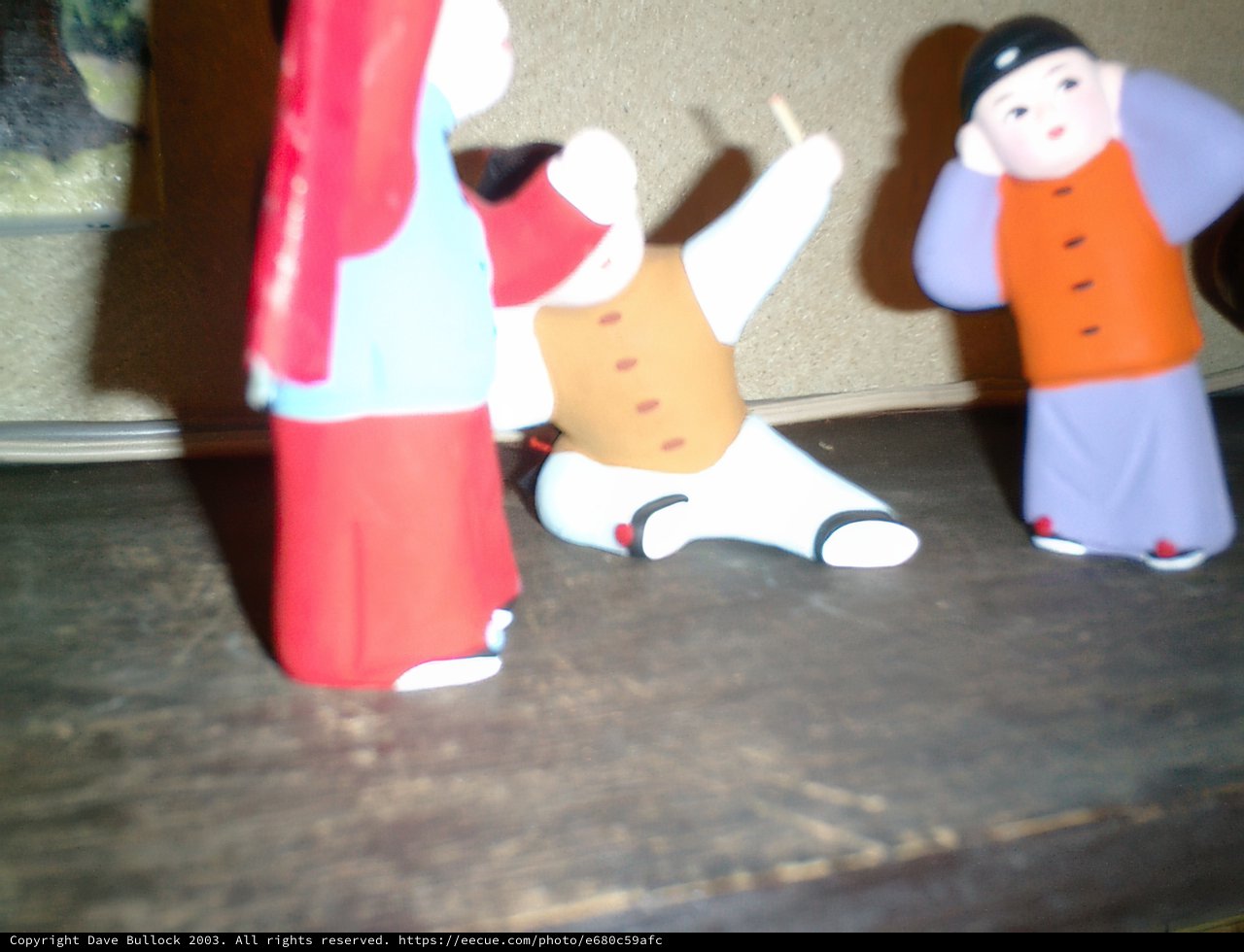Three figurines with a baby on a table