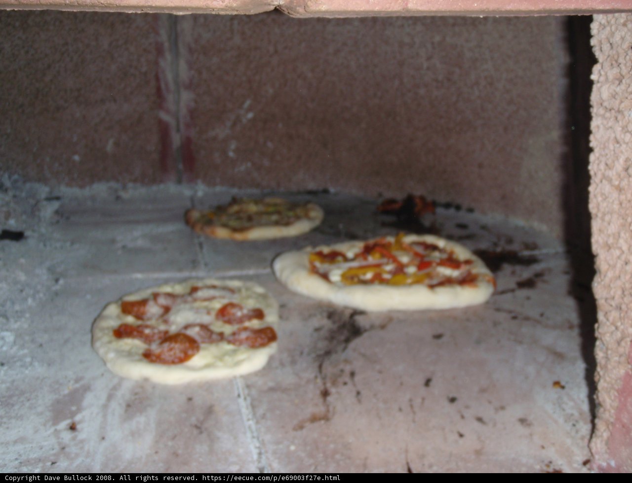 Three Delicious Pizzas in the Oven