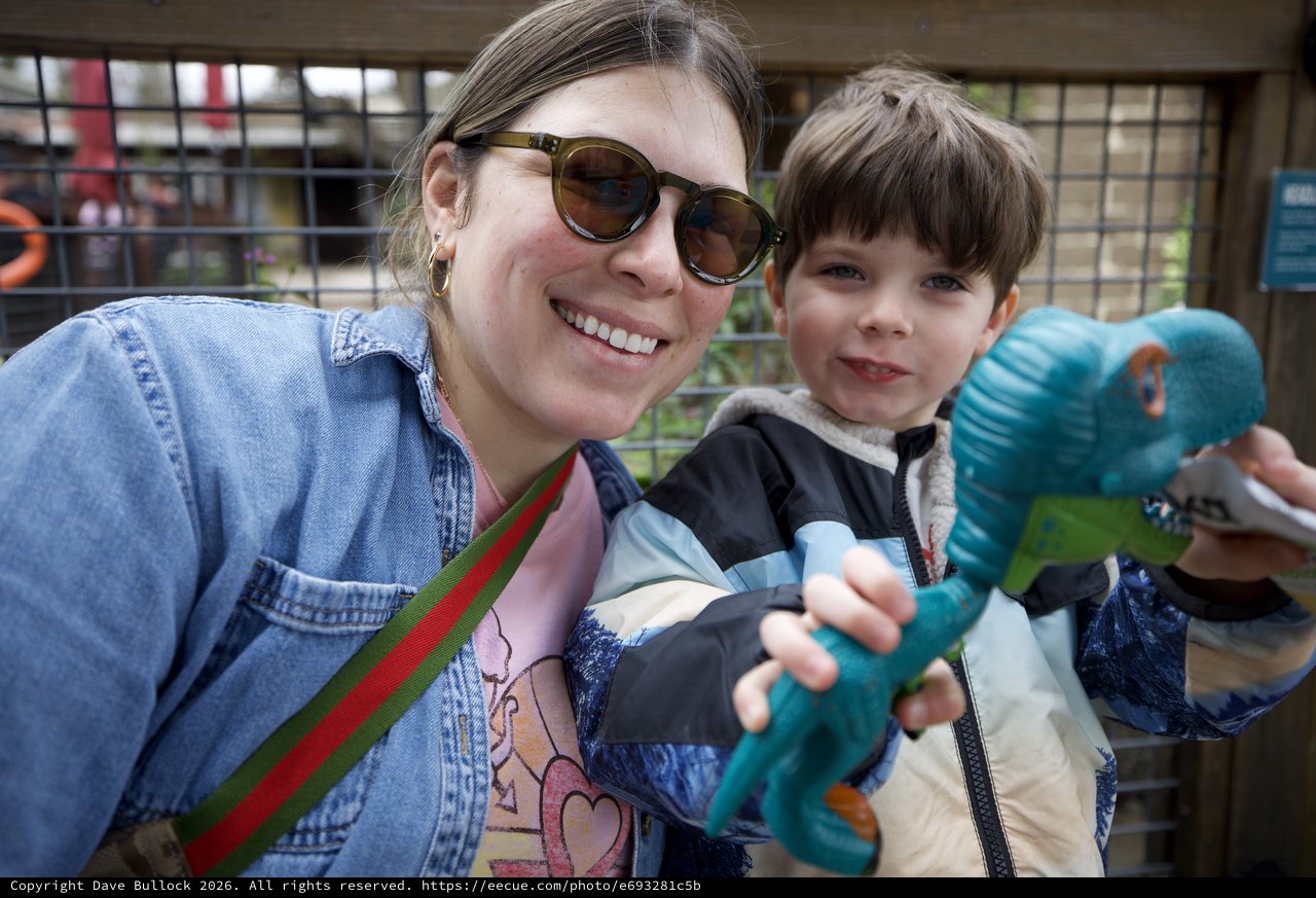 Mother and Son with Dinosaur Toy at Zoo