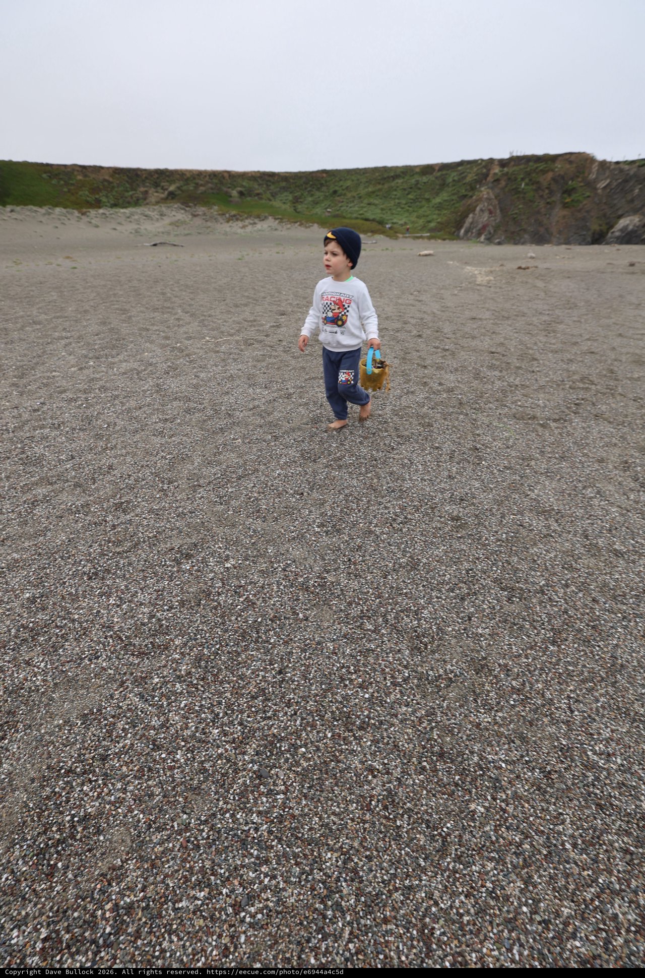 Young Explorer Roaming a Rugged Coastal Beach