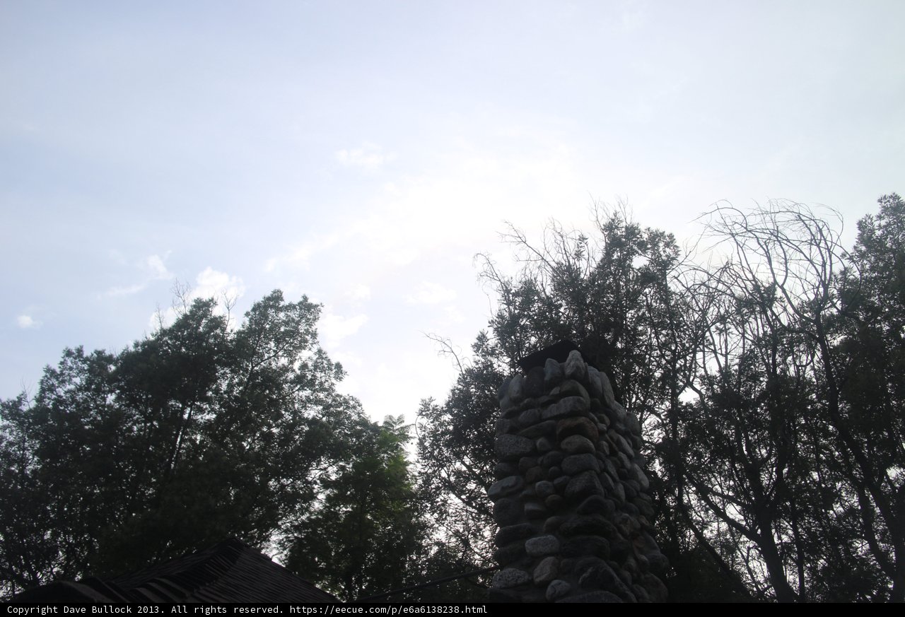 Rustic Stone Chimney and Tree Silhouette