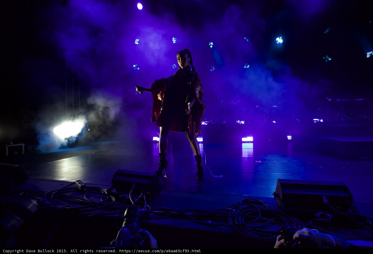 FKA twigs Full Body Wide Shot Standing Arm Extended Microphone Kimono Flowing Red Brocade Black Bodysuit Boots Spotlight Moon Heavy Haze Photographer