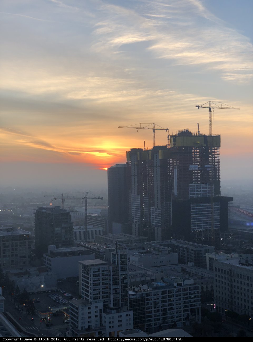 Urban Sunset with Construction Cranes