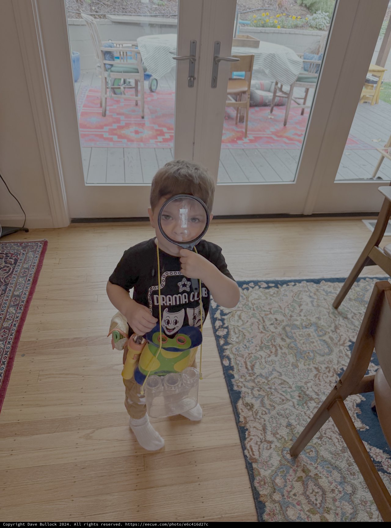 Child Playing Detective with Magnifying Glass