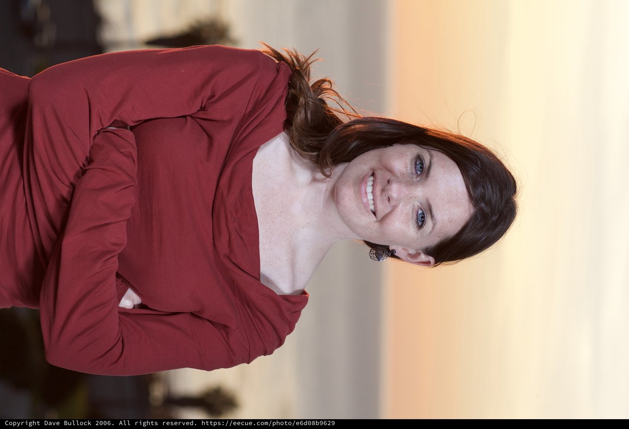 Smiling Woman in Red at Coastal Sunset