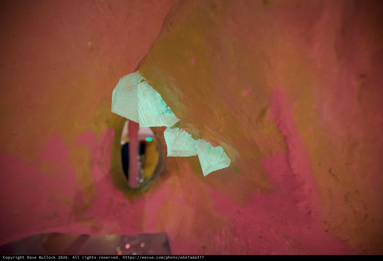 Peeling Paint and Torn Paper in Pink Adobe Wall