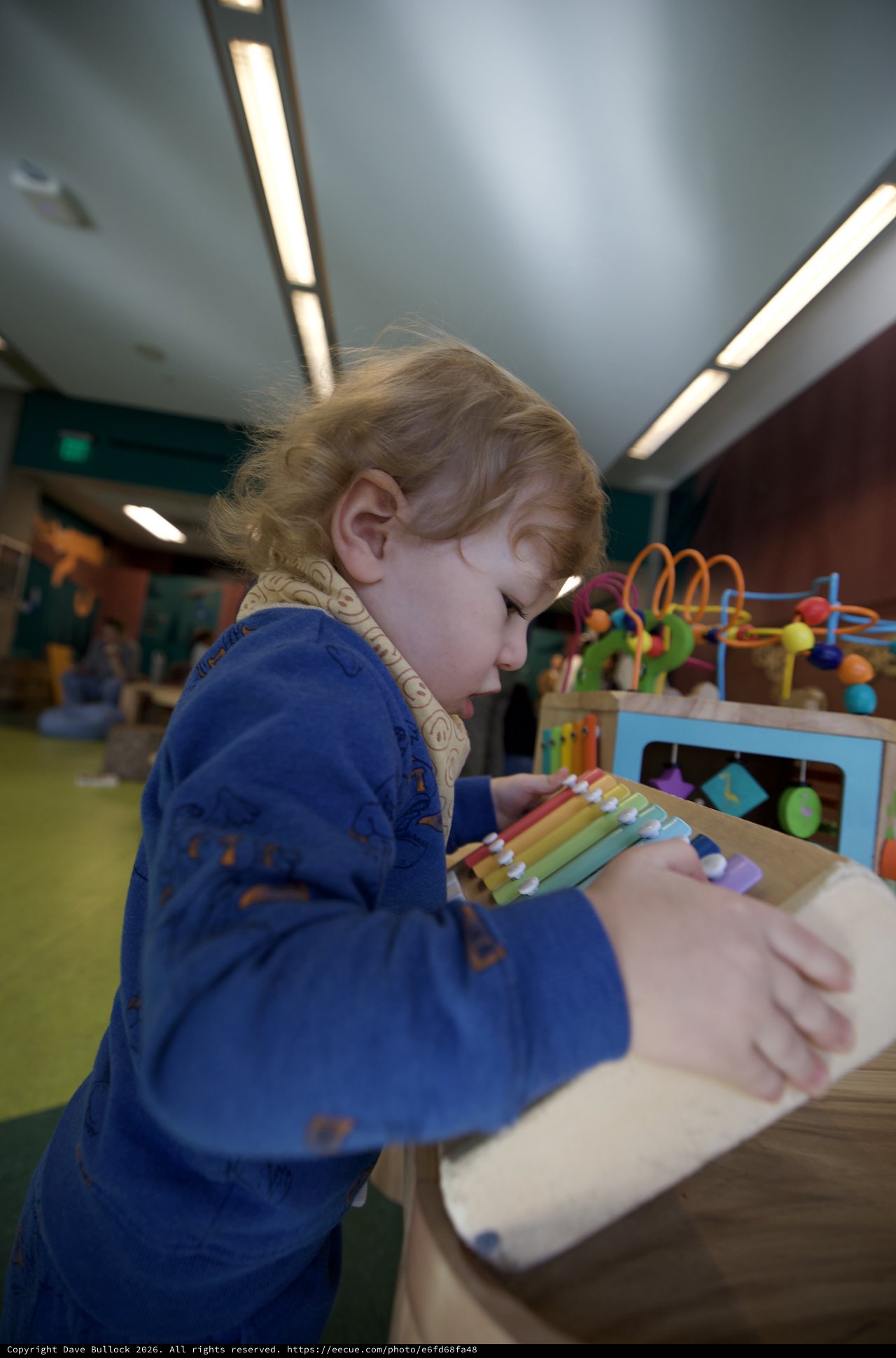 Young Child Exploring Educational Toys in Play Space