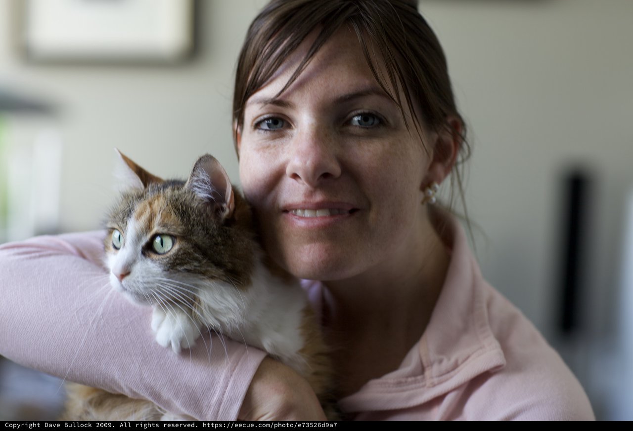 Woman and Her Calico Cat Share a Tender Moment