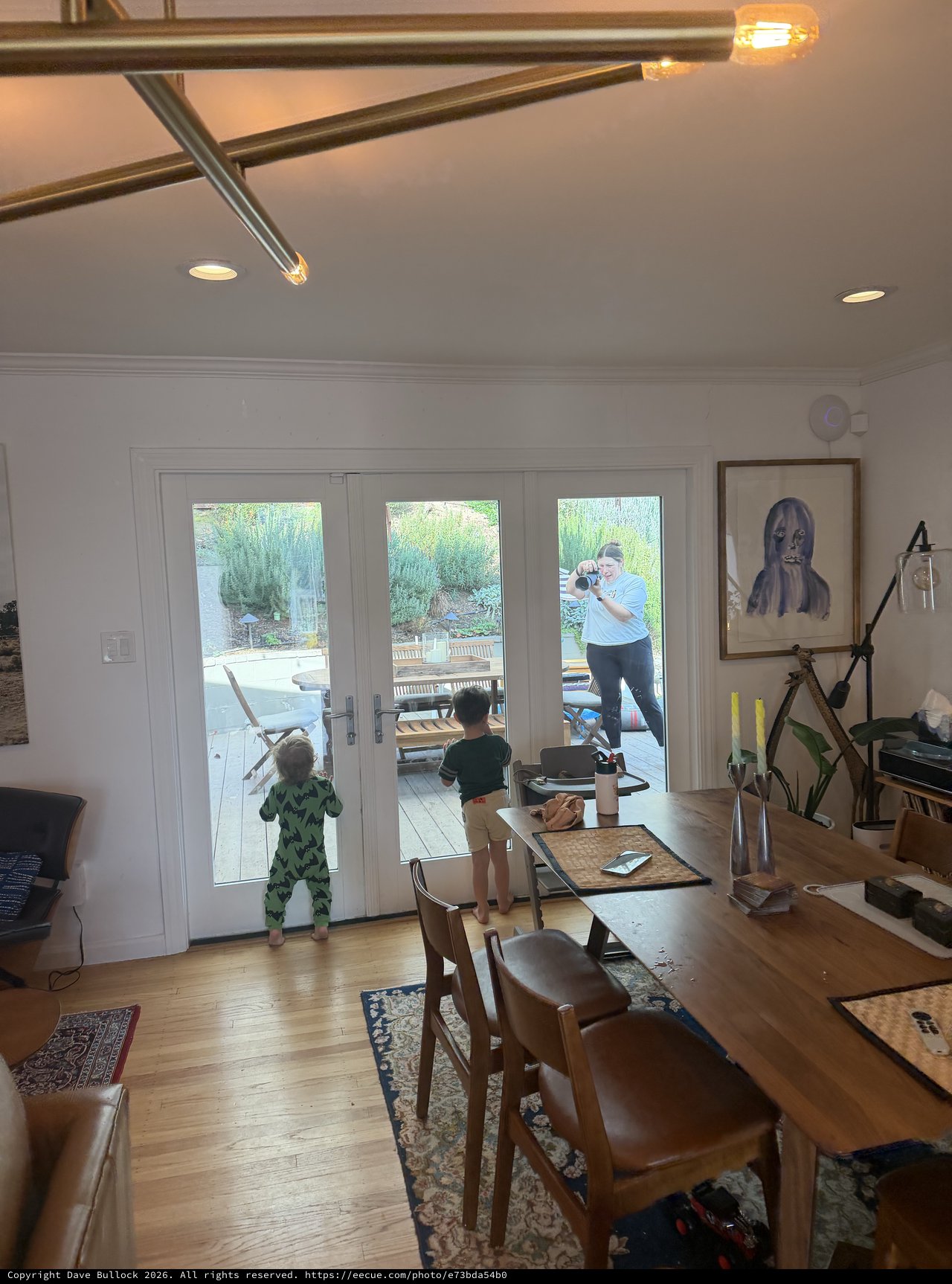 Family Moment Through Glass Doors at Home