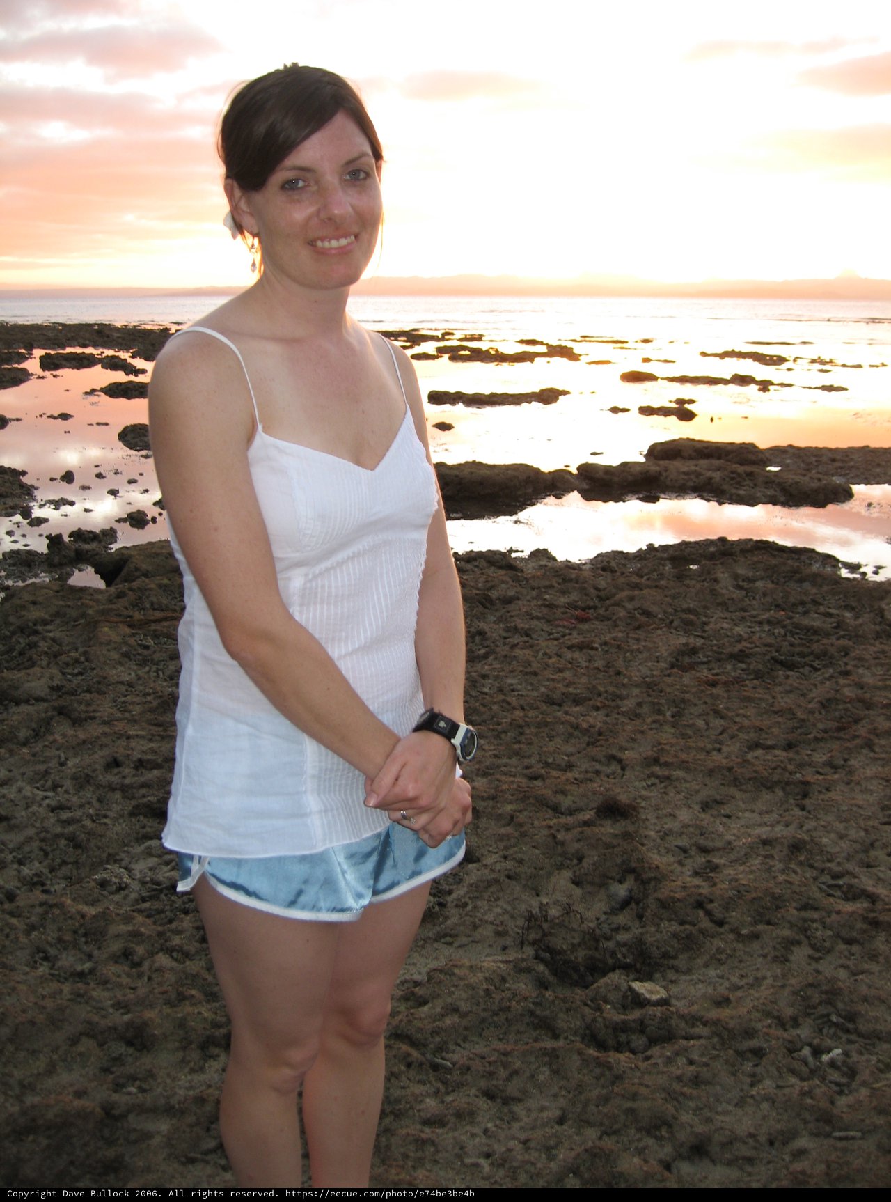 Woman Smiling at Rocky Fiji Beach Sunset